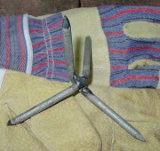 Contemporary caltrop improvised from large nails welded together.